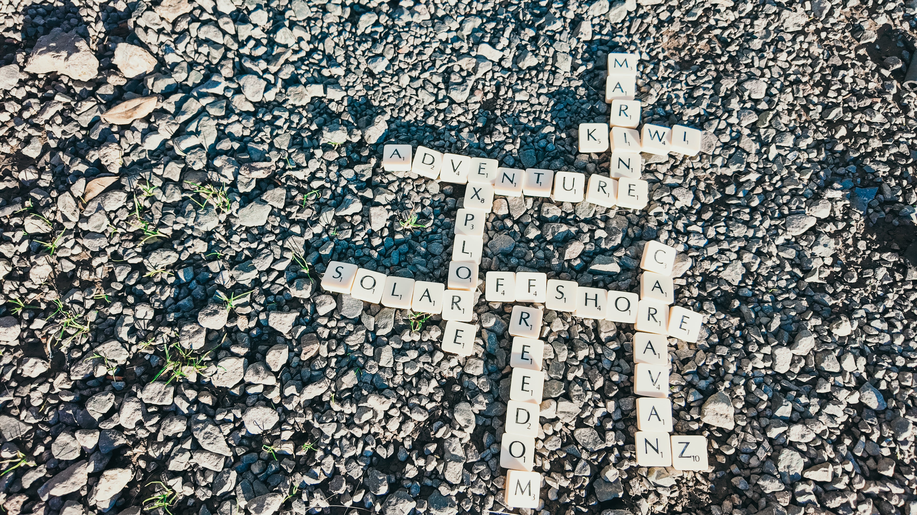 Scrabble tiles spelling adventure, marine, caravan and more