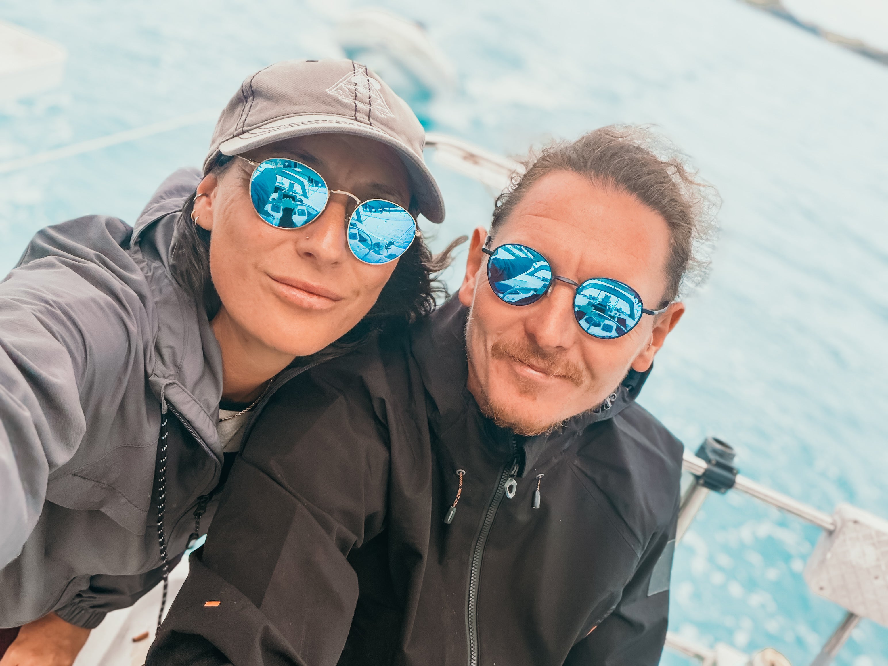 Ash and Vee on their sailboat in New Zealand